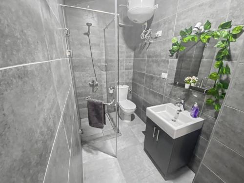 a bathroom with a shower and a sink and a toilet at 3BR 2BA Retreat with Four Pools Gym and Onsite Dining Close to El Gouna in Hurghada