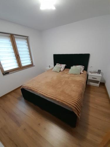 a bedroom with a large bed with two pillows at Casa de vacanta Gea Transalpina in Şugag