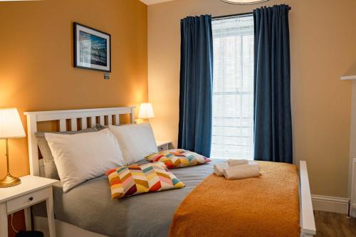 a bedroom with a bed with two pillows and a window at 32 Bondgate Without in Alnwick