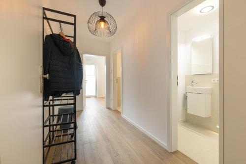 a room with a ladder and a hallway at Chiemsee Apartment 17 in Übersee