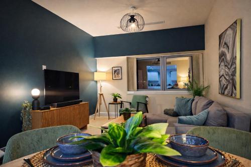a living room with a couch and a table at 2 Bed Flat - Contractor - Central MK - Parking - Sleeps5 in Milton Keynes