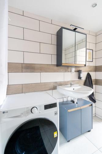 a washing machine in a bathroom with a sink at Large Maisonette I 90 m2 I For Groups & Families I 9 Guests I 3 Rooms in Kapfenberg