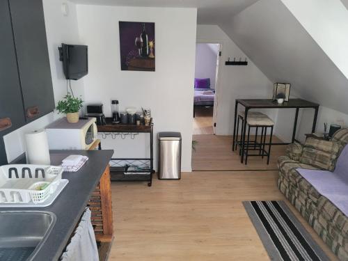 a living room with a couch and a table at Cute apartment close to highway in Edmundston