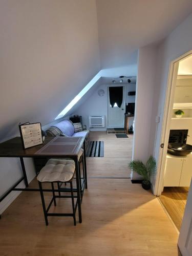 a living room with a dining room table and a staircase at Cute apartment close to highway in Edmundston
