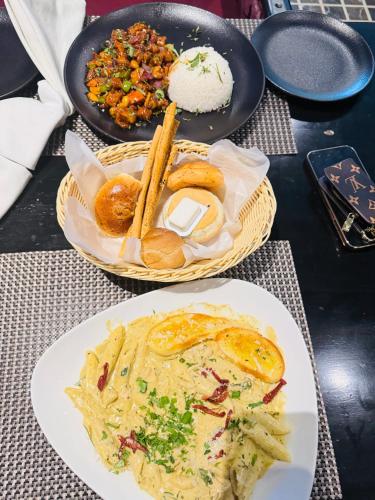 a table with two plates of food on a table at Taj Signature Hotel - F7 Markaz Islamabad in Islamabad