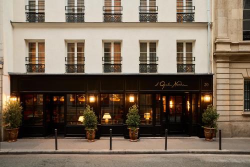 a store front of a building with potted plants at L'Opale Noire in Paris