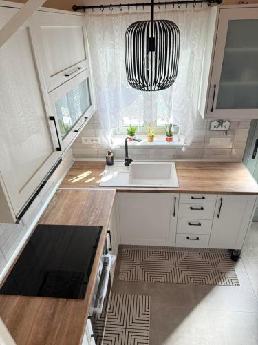 a small kitchen with a sink and a window at Spitaki in Kremasti