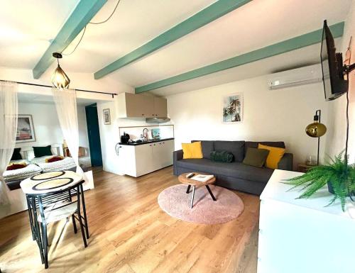 a living room with a couch and a table at Cozy comfortable house with jacuzzi & private garden near Amsterdam in Vijfhuizen