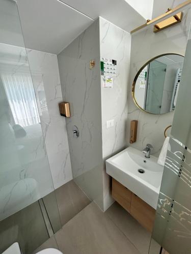 a bathroom with a shower and a sink and a mirror at Casa D'Agostino in Santiago