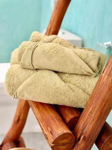a brown towel sitting on top of a wooden chair at Olacoco by Olamanga in Jambiani
