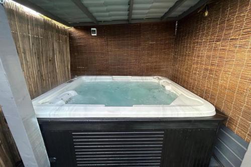 a jacuzzi tub in a brick wall at Cozy comfortable house with jacuzzi & private garden near Amsterdam in Vijfhuizen