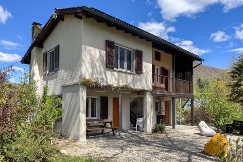 a white house with a porch and a balcony at Casa Roccolo in Astano