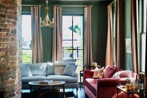 a living room with a couch and a table at The Juliette - Luxury Historic Residence in Charleston