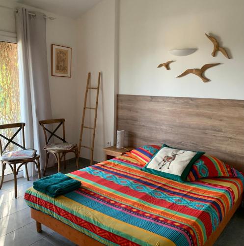 a bedroom with a bed with birds on the wall at La Escala in La Celle-sous-Gouzon