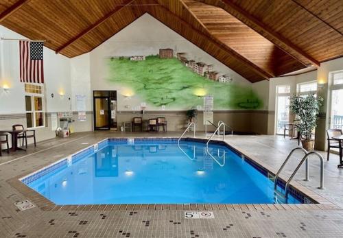 a large swimming pool in a building with a mural at Unit 411B 1Bd 1Ba Efficiency Condo Condo in Birchwood