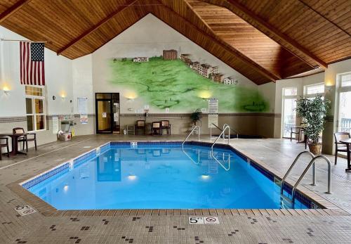 a large pool in a hotel with a mural on the wall at Unit 207 2 BDRM 2 BA condo in Birchwood