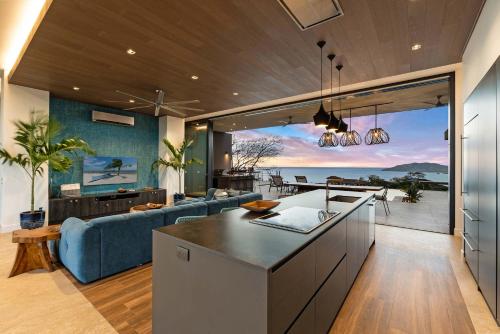 a kitchen and living room with a view of the ocean at Infinity Pool Villa , 4 Suites & Private Casita in Tamarindo