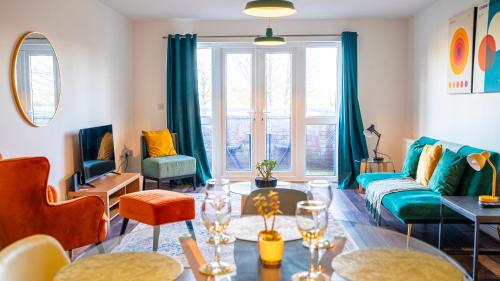 a living room with a couch and a table at Modern 2BR 2BATH Apt Cardiff Bay Parking in Cardiff