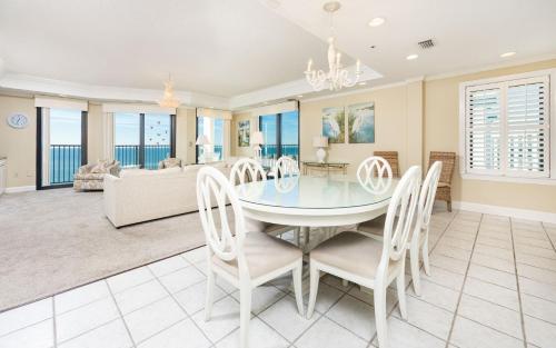 a dining room and living room with a table and chairs at Phoenix East 1401 in Orange Beach