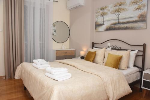 a bedroom with a large bed with towels on it at Sparta Central Apartment with Free Parking in Sparta