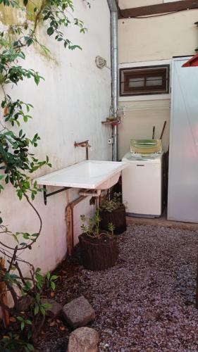 a small kitchen with a sink and a refrigerator at Apart Don Ángel Tandil in Tandil