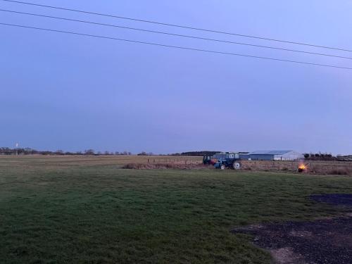 a truck parked in a field with a building at The Truck in Longframlington