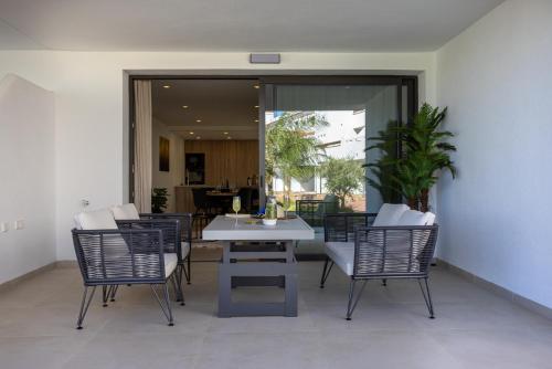 a dining room with a white table and chairs at Serenity Garden & Spa in Los Alcázares