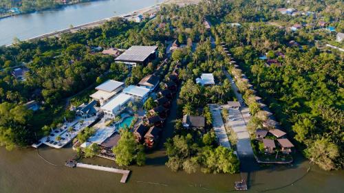 an aerial view of a house in the water at The Grace Amphawa in Amphawa