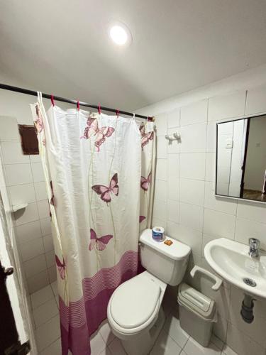 a bathroom with a toilet and a sink at Refugio Pantu in Cabo de la Vela