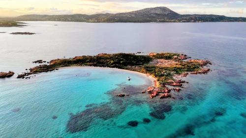 an island in a body of water at Sleeping on a boat in the Island's bay in Porto San Paolo