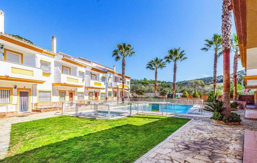 a villa with a swimming pool and palm trees at La Escapadita in Benaoján