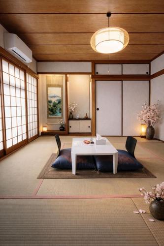 a living room with a white table and chairs at women only 女性専用 しげの里松福 in Takamatsu