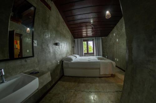 a bedroom with a bed and a tub and a sink at Contemporary architecture by the sea in Búzios