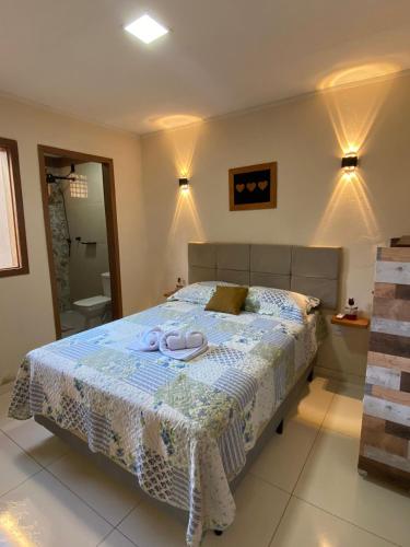 a bedroom with a bed with two towels on it at Recanto do Ofurô in Ilhéus