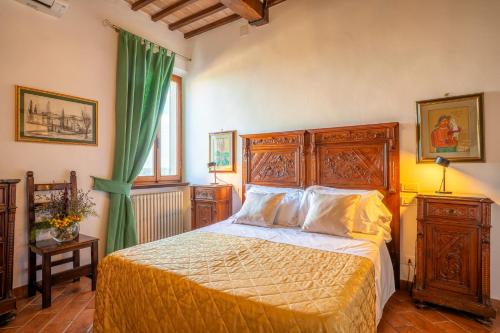 a bedroom with a bed and a green curtain at La Corte Medicea in Montepulciano
