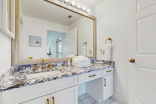 a bathroom with a sink and a mirror at Navarre Beach Regency 203 in Navarre