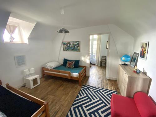 a living room with a red couch and a table at Les forts in Leigné-les-Bois