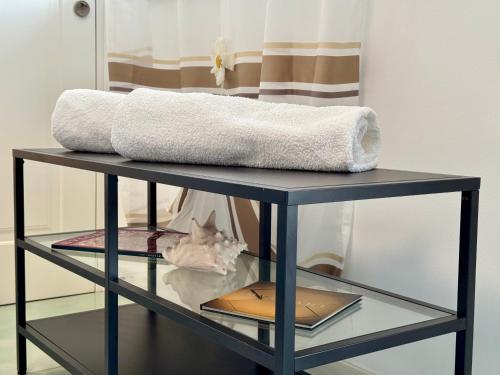 a glass shelf with a towel on top of it at Aurora View Resort - Boutique Suites in Mascali