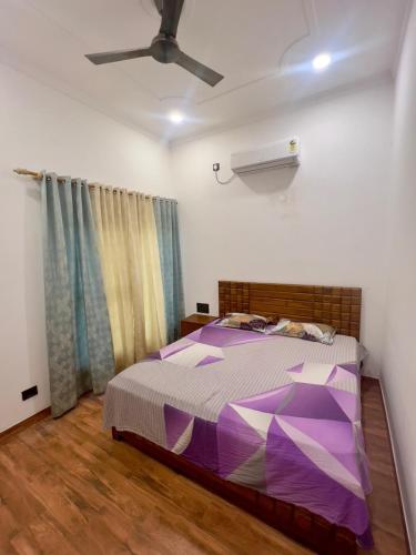 a bedroom with a bed and a ceiling fan at Mananjay Natures Retreat in Jāmb
