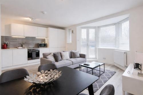 a living room with a couch and a table at Roomspace Serviced Apartments - Kew Bridge Court in London