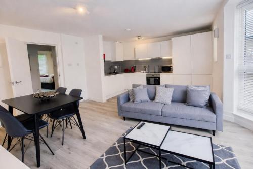 a living room with a couch and a table at Roomspace Serviced Apartments - Kew Bridge Court in London