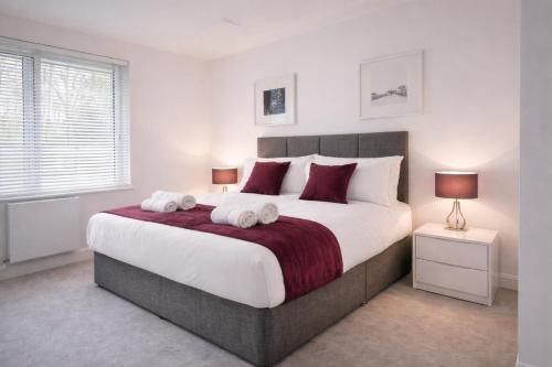 a bedroom with a large bed with two towels on it at Roomspace Serviced Apartments - Kew Bridge Court in London