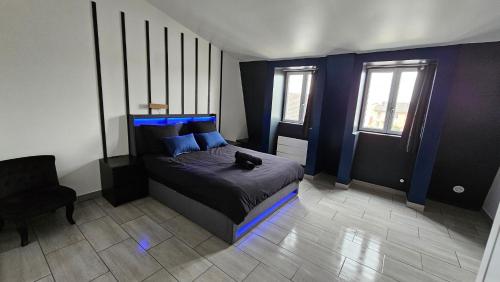 a bedroom with a black cat sitting on a bed at Blue Duplex Proche Paris & Stade De France in Drancy