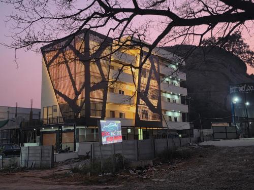 a building with a tree in front of it at Hangang HOTEL 한강호텔 in Jāmb