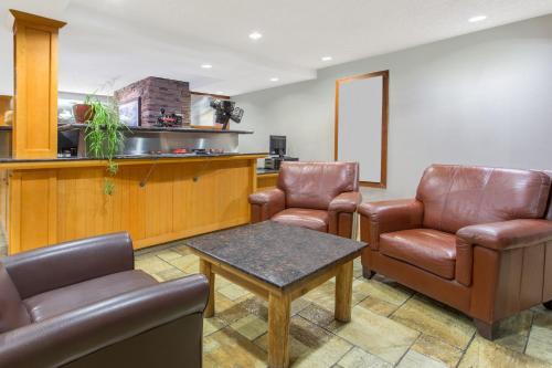 a living room filled with furniture and a coffee table at Canmore Inn & Suites in Canmore