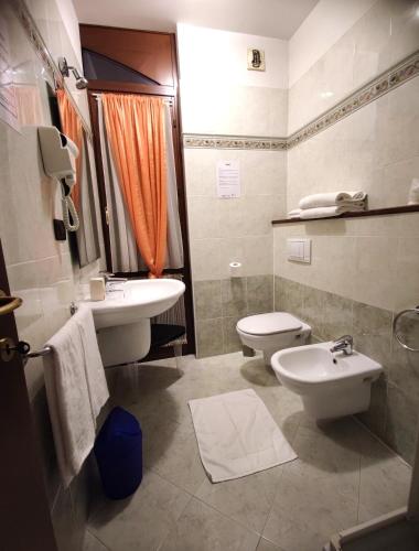 a bathroom with a sink and a toilet at Alisea Eco Residence in Pocapaglia