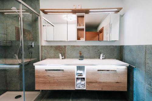 a bathroom with a sink and a shower at App. Marlos in Leisach