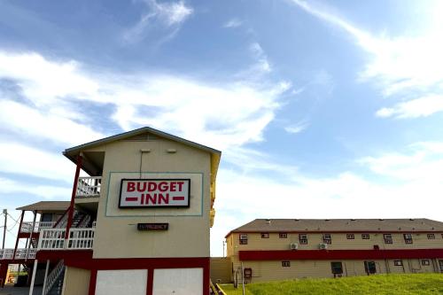 a building with a sign for a buffet inn at Budget Inn By OYO Corpus Christi Beach in Corpus Christi