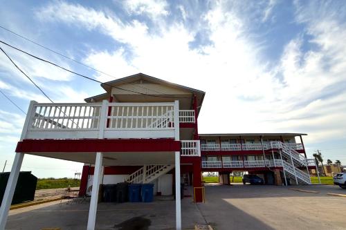 a building with a white staircase on the side of it at Budget Inn By OYO Corpus Christi Beach in Corpus Christi