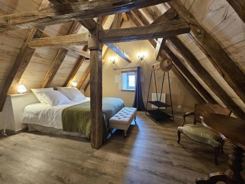 a bedroom with a large bed in a attic at Le logis in Mairé